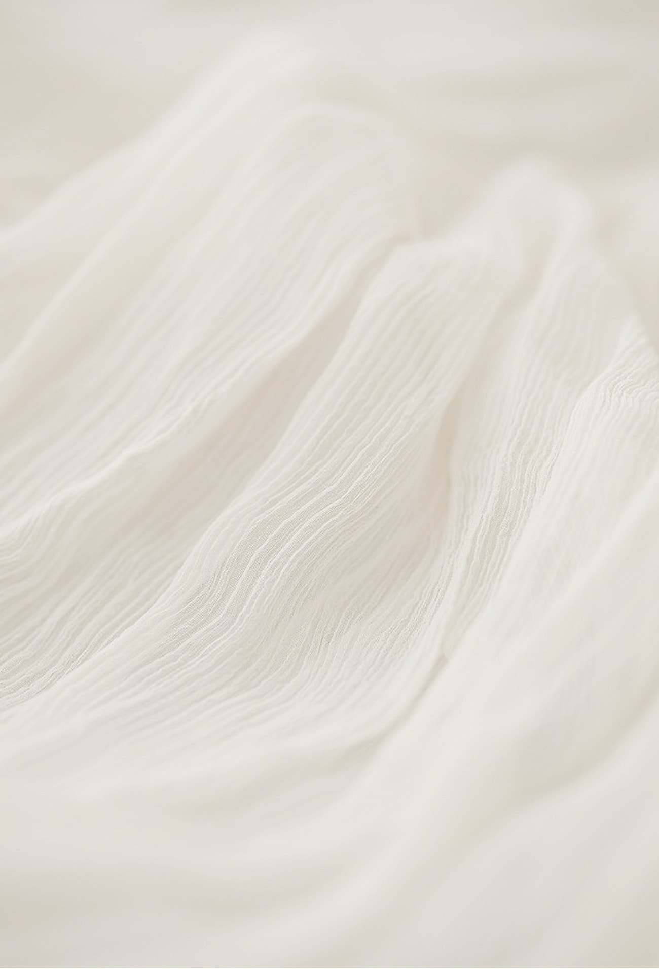 Close-up of flowing white fabric texture.