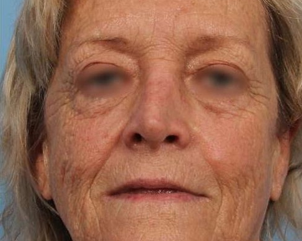 Close-up portrait of an elderly woman.