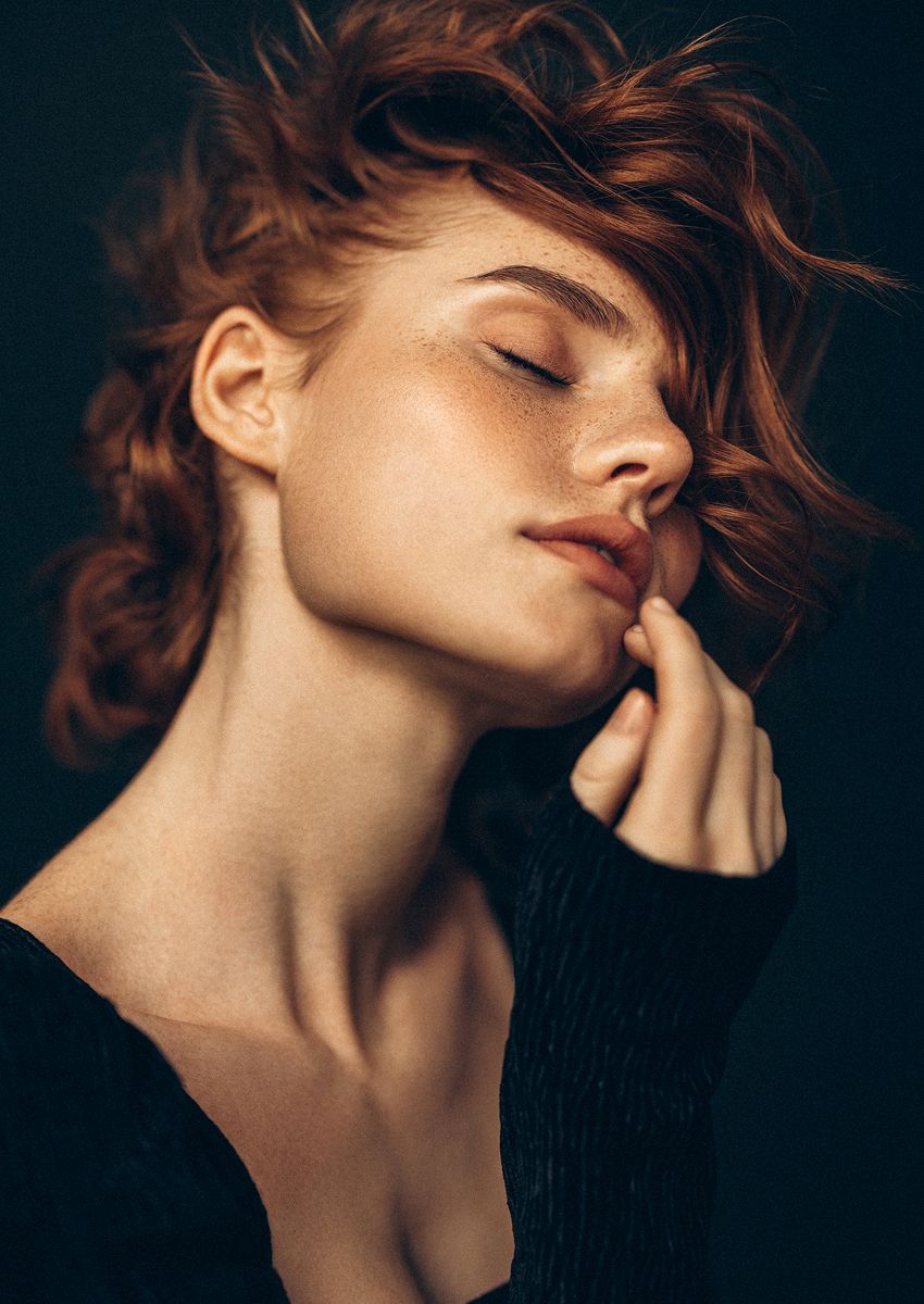 Close-up of a woman's face with windblown hair.