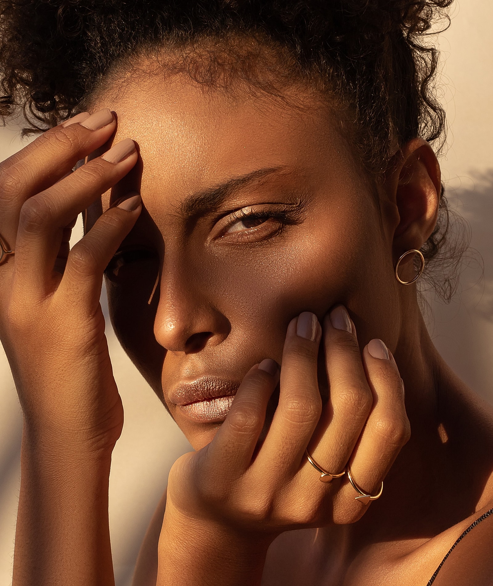 Woman gently touching her neck, eyes closed.